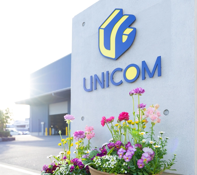 UNICOMの工場外観と花壇